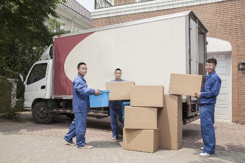 Professional house removals team in Fulham handling moving boxes