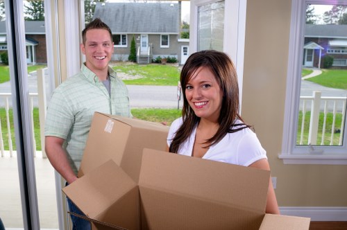 Local movers handling furniture in a Fulham flat move