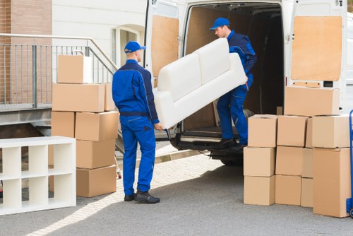 Local moving team transporting boxes in Fulham