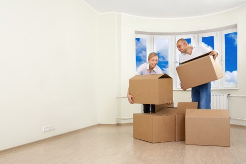 Professional movers carrying items from a Fulham apartment building